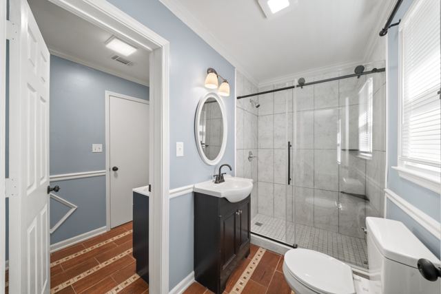 Bath with a glass-enclosed walk-in shower