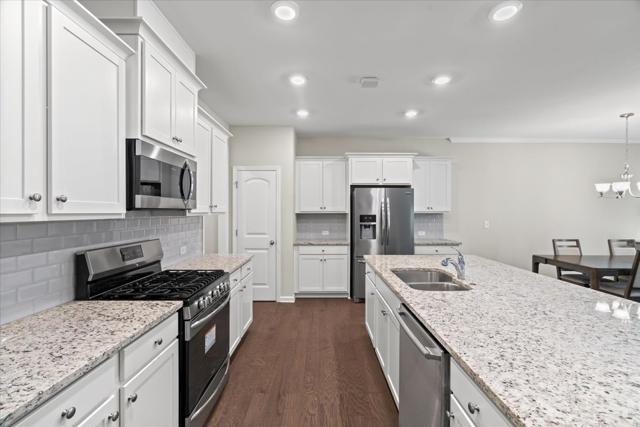 Kitchen with stainless steel appliances and subway tile