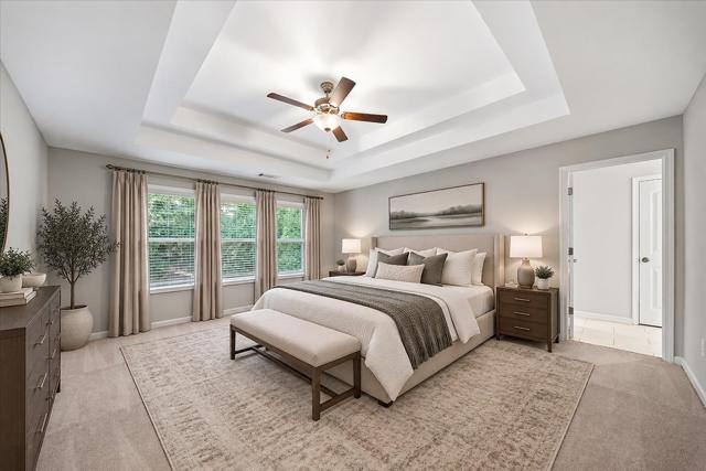 Primary bedroom with a tray ceiling
