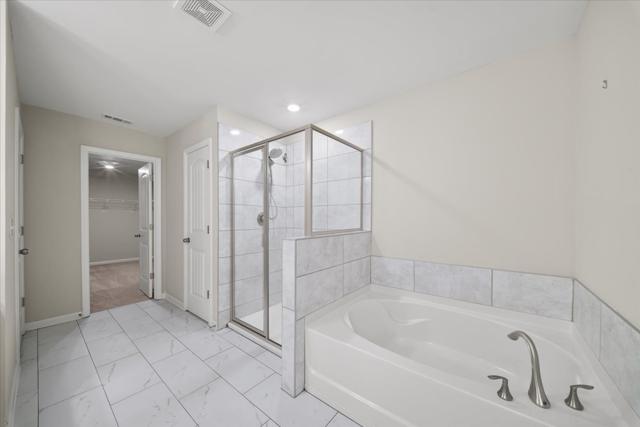 Primary bath with a soaking tub and glass shower
